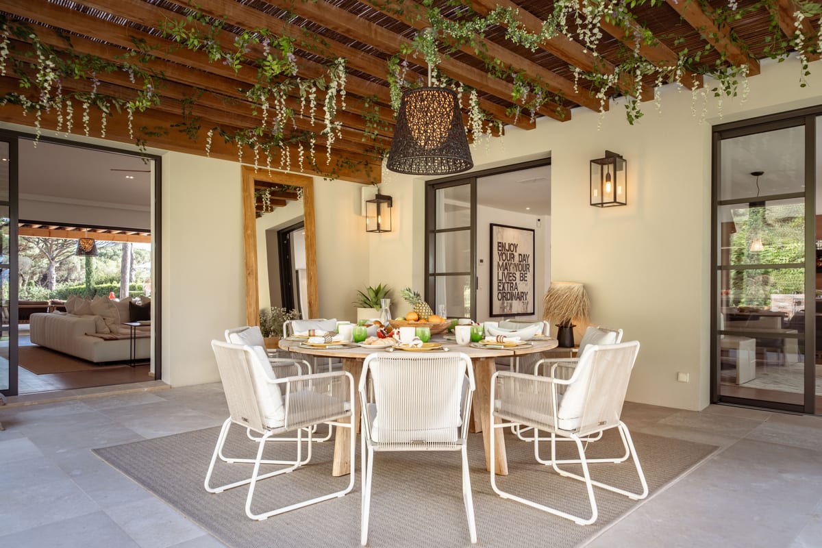 The same table with the glazed doors folded back onto the living room.